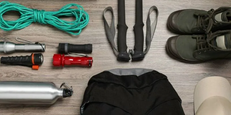 Hiking clothes, boots, and gear arranged for outdoor trail preparation