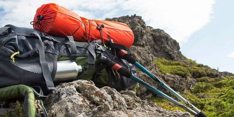 Hiking backpack packed with essentials like map, food, and first aid kit