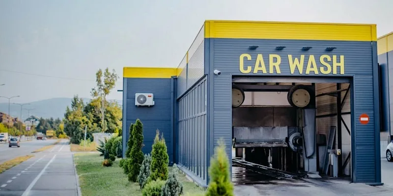 High pressure cleaning tent carpet at self service car wash station