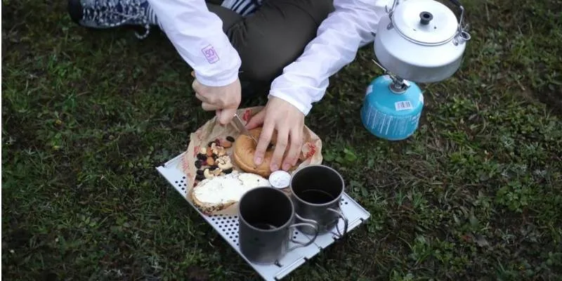 Healthy hiking snacks and water bottle prepared for outdoor hiking trip