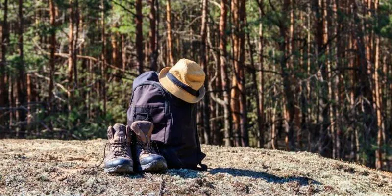 Hiker resting on trail while managing energy during mountain hike