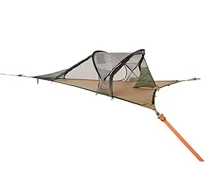 Tentsile Connect Tree Tent with mosquito net suspended between trees for camping